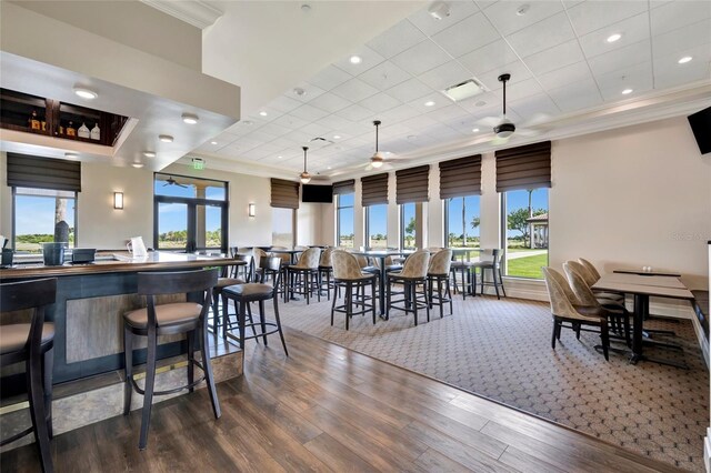 23233 Banbury Way Unit 302, Venice, FL 34293 - dining room featuring crown molding, wood finished floors, ceiling fan, and a paneled ceiling