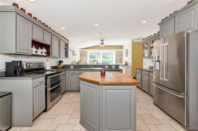 230 Fareham Dr, Venice, FL 34293 - kitchen featuring stainless steel appliances, gray cabinets, butcher block counters, a center island, and a sink