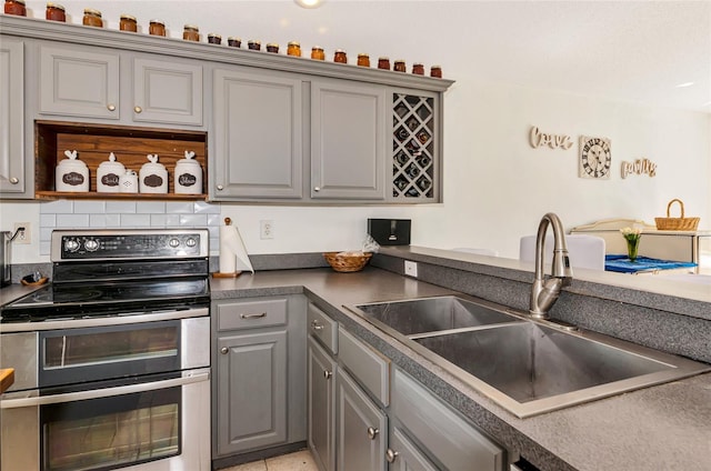 230 Fareham Dr, Venice, FL 34293 - kitchen with gray cabinetry, double oven range, a sink, open shelves, and dark countertops