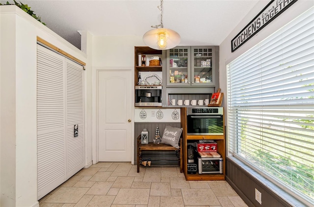 230 Fareham Dr, Venice, FL 34293 - bar area with stainless steel oven and stone tile floors