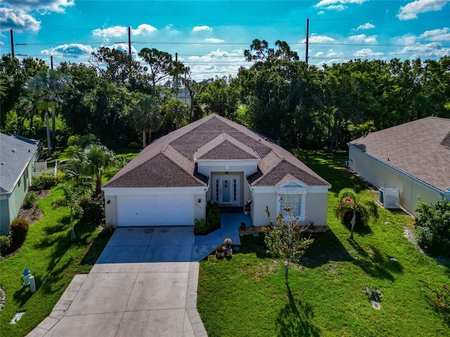 230 Fareham Dr, Venice, FL 34293 - single story home featuring french doors, driveway, a garage, a front lawn, and a shingled roof