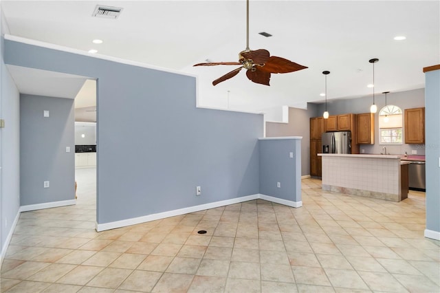 296 Pine Ranch Trl, Osprey, FL 34229 - kitchen with stainless steel appliances, ceiling fan, recessed lighting, light countertops, and hanging light fixtures