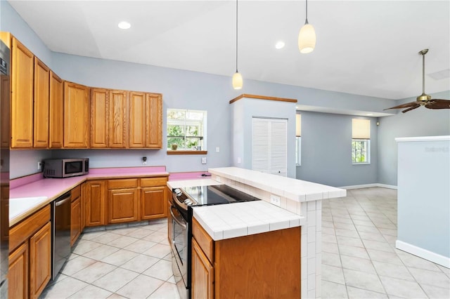 296 Pine Ranch Trl, Osprey, FL 34229 - kitchen with appliances with stainless steel finishes, a center island, light tile patterned floors, plenty of natural light, and recessed lighting