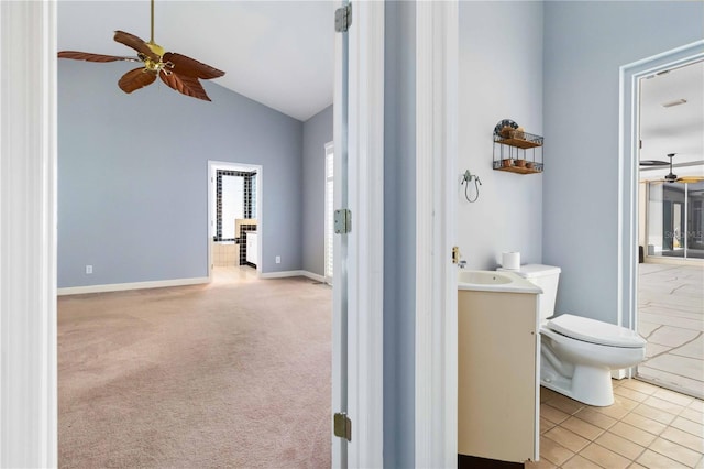 296 Pine Ranch Trl, Osprey, FL 34229 - bathroom featuring ceiling fan, vanity, toilet, high vaulted ceiling, and baseboards