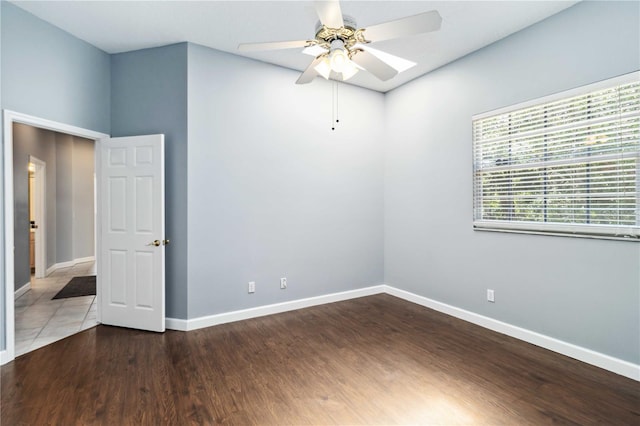 296 Pine Ranch Trl, Osprey, FL 34229 - empty room with a ceiling fan, wood finished floors, and baseboards