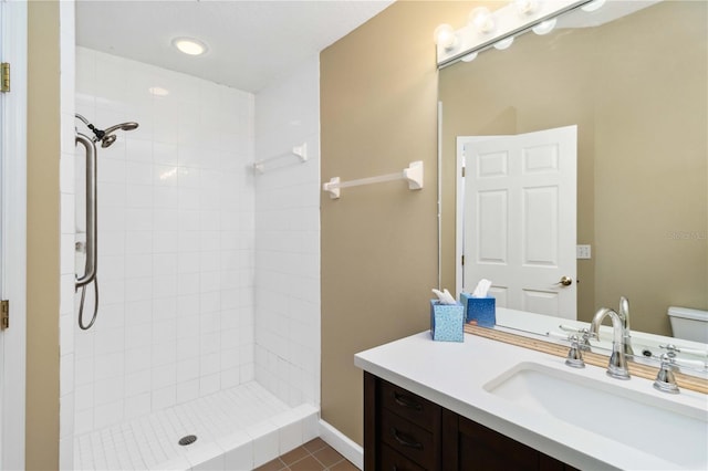 296 Pine Ranch Trl, Osprey, FL 34229 - bathroom featuring vanity, toilet, a tile shower, tile patterned floors, and baseboards