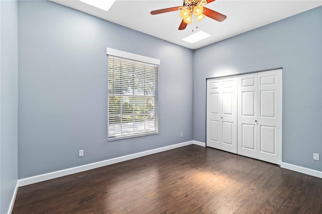 296 Pine Ranch Trl, Osprey, FL 34229 - unfurnished bedroom with a skylight, dark wood-style floors, baseboards, a closet, and ceiling fan
