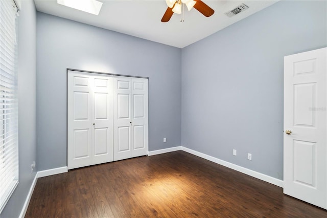 296 Pine Ranch Trl, Osprey, FL 34229 - unfurnished bedroom featuring baseboards, dark wood-style flooring, and multiple windows