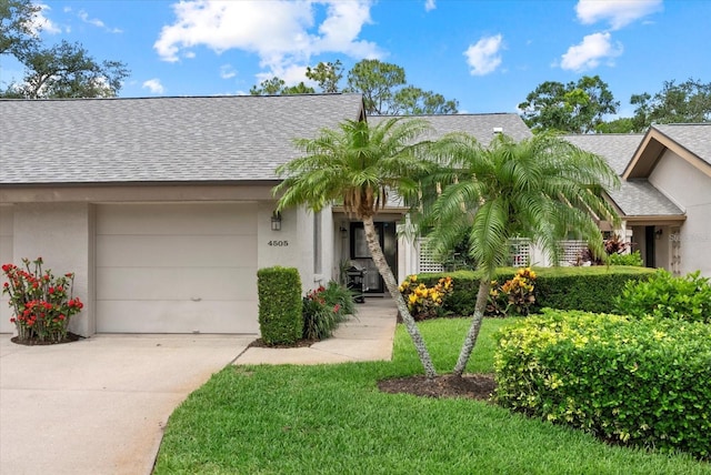 4505 Kingsmere Unit 2, Sarasota, FL 34235 - view of front of home with driveway, a shingled roof, stucco siding, and a garage