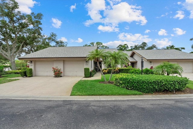 4505 Kingsmere Unit 2, Sarasota, FL 34235 - single story home with driveway, an attached garage, stucco siding, and a front lawn