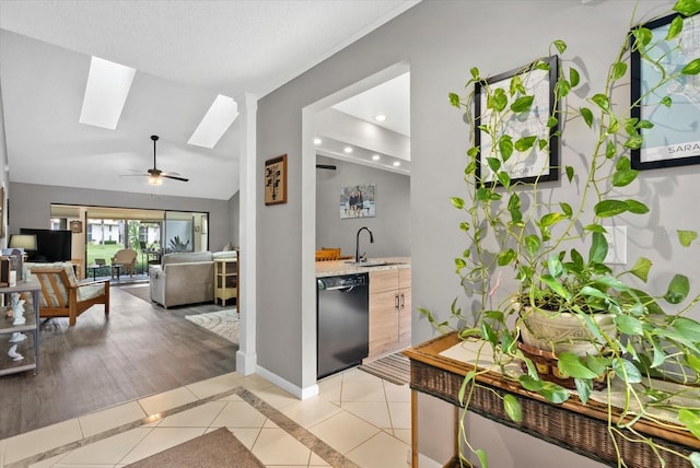 4505 Kingsmere Unit 2, Sarasota, FL 34235 - kitchen featuring dishwasher, light tile patterned flooring, lofted ceiling, a skylight, and a ceiling fan