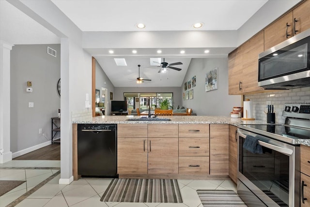 4505 Kingsmere Unit 2, Sarasota, FL 34235 - kitchen with stainless steel appliances, a sink, tasteful backsplash, recessed lighting, and vaulted ceiling