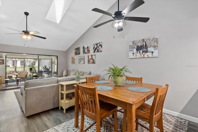 4505 Kingsmere Unit 2, Sarasota, FL 34235 - dining area featuring ceiling fan, high vaulted ceiling, wood finished floors, a skylight, and baseboards