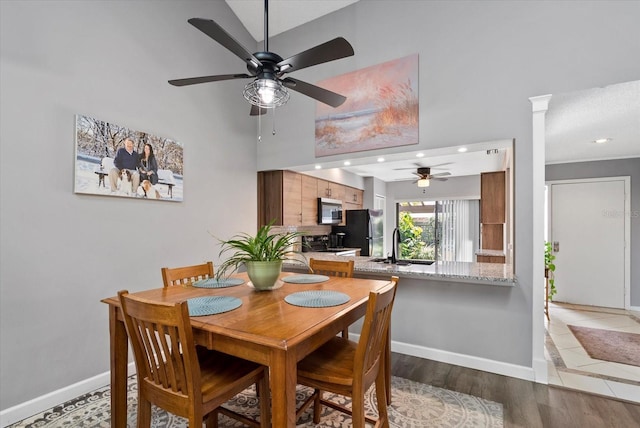 4505 Kingsmere Unit 2, Sarasota, FL 34235 - dining space featuring ceiling fan, a high ceiling, baseboards, decorative columns, and recessed lighting