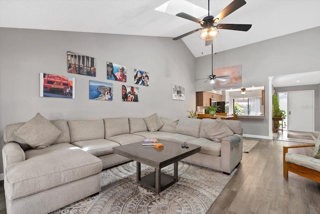 4505 Kingsmere Unit 2, Sarasota, FL 34235 - living room featuring ceiling fan, wood finished floors, baseboards, and high vaulted ceiling