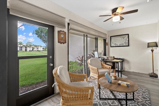 4505 Kingsmere Unit 2, Sarasota, FL 34235 - living area featuring a textured wall, wood finished floors, and a ceiling fan