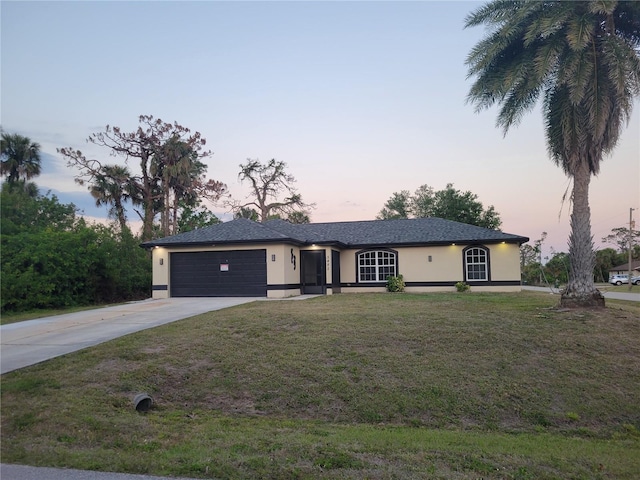 5482 Globe Ter, North Port, FL 34286 - ranch-style house featuring stucco siding, driveway, an attached garage, and a front yard