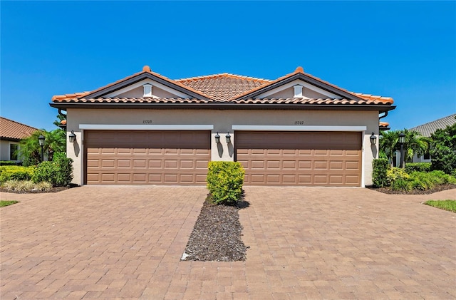 15707 Sacile Ln, Bradenton, FL 34211 - mediterranean / spanish-style house with a garage, decorative driveway, stucco siding, and a tile roof