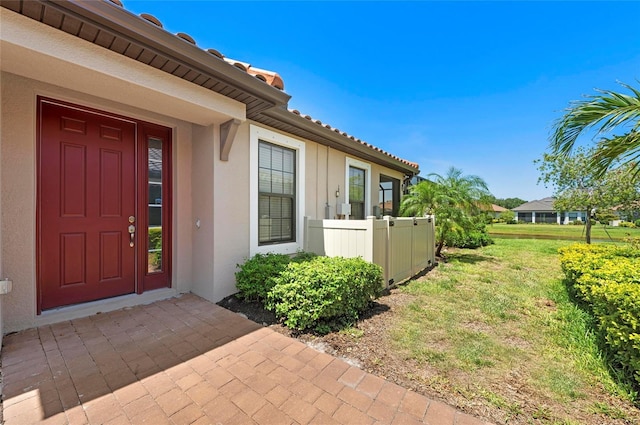 15707 Sacile Ln, Bradenton, FL 34211 - doorway to property featuring stucco siding and a lawn