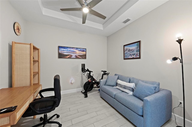 15707 Sacile Ln, Bradenton, FL 34211 - home office featuring a raised ceiling, a ceiling fan, light wood-style flooring, and baseboards