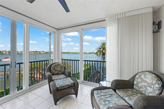 1280 Dolphin Bay Way Unit 204, Sarasota, FL 34242 - sunroom with a water view, a textured ceiling, tile patterned flooring, and plenty of natural light