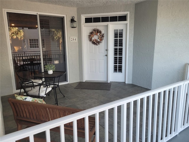 1280 Dolphin Bay Way Unit 204, Sarasota, FL 34242 - view of exterior entry with stucco siding and covered porch
