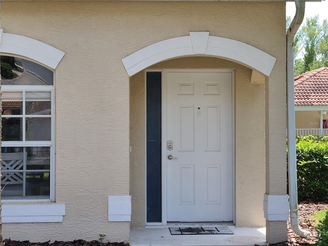 7273 Cedar Hollow Cir Unit 102, Bradenton, FL 34203 - view of exterior entry with stucco siding and a tiled roof