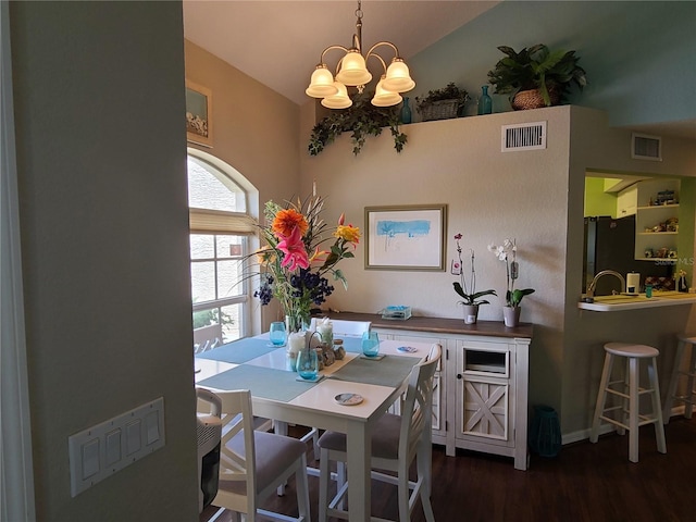 7273 Cedar Hollow Cir Unit 102, Bradenton, FL 34203 - dining space featuring a chandelier, wood finished floors, lofted ceiling, and baseboards