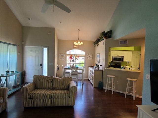 7273 Cedar Hollow Cir Unit 102, Bradenton, FL 34203 - living area with high vaulted ceiling, a chandelier, dark wood-type flooring, a ceiling fan, and baseboards