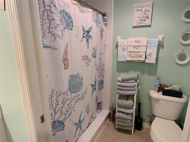 7273 Cedar Hollow Cir Unit 102, Bradenton, FL 34203 - bathroom featuring tile patterned flooring, toilet, and a shower stall