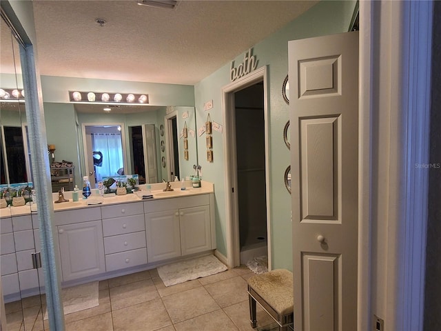 7273 Cedar Hollow Cir Unit 102, Bradenton, FL 34203 - full bath with double vanity, tile patterned flooring, and a textured ceiling
