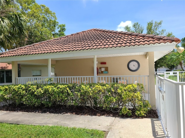 7273 Cedar Hollow Cir Unit 102, Bradenton, FL 34203 - view of front facade with a tile roof, stucco siding, and covered porch