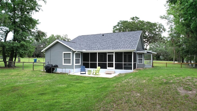 3287 Rackley Rd, Brooksville, FL 34604 - back of property featuring a sunroom, roof with shingles, and a patio