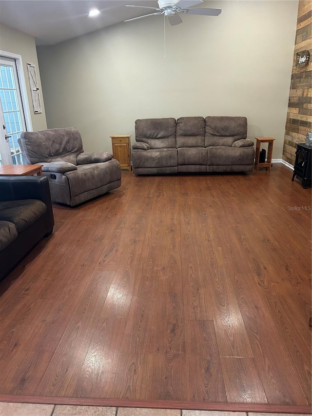 3287 Rackley Rd, Brooksville, FL 34604 - living room featuring ceiling fan, wood finished floors, baseboards, and a wood stove
