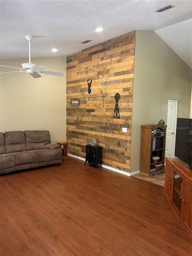 3287 Rackley Rd, Brooksville, FL 34604 - living area with wood finished floors, a textured ceiling, lofted ceiling, and ceiling fan