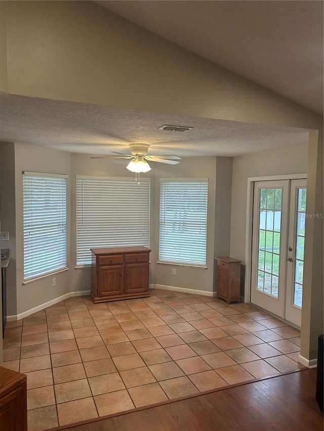 3287 Rackley Rd, Brooksville, FL 34604 - unfurnished living room featuring light tile patterned flooring, baseboards, a ceiling fan, french doors, and vaulted ceiling
