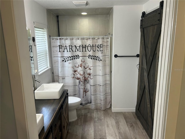 3287 Rackley Rd, Brooksville, FL 34604 - bathroom featuring wood finished floors, toilet, vanity, and curtained shower