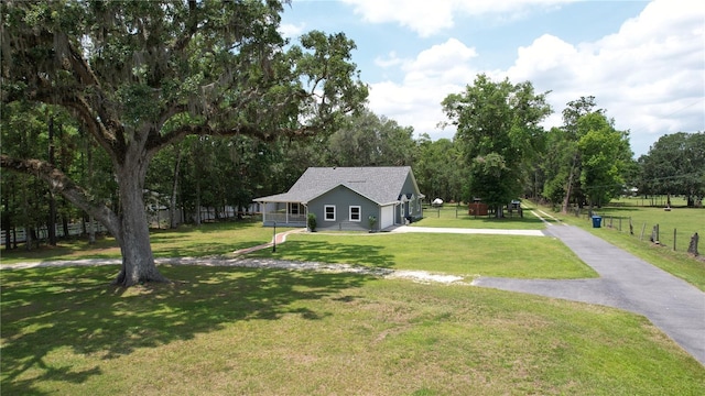 3287 Rackley Rd, Brooksville, FL 34604 - view of front facade with driveway, a front yard, a garage, and view of wooded area