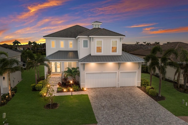 5718 Title Row Dr, Bradenton, FL 34210 - view of front facade with a standing seam roof, decorative driveway, a front yard, and stucco siding