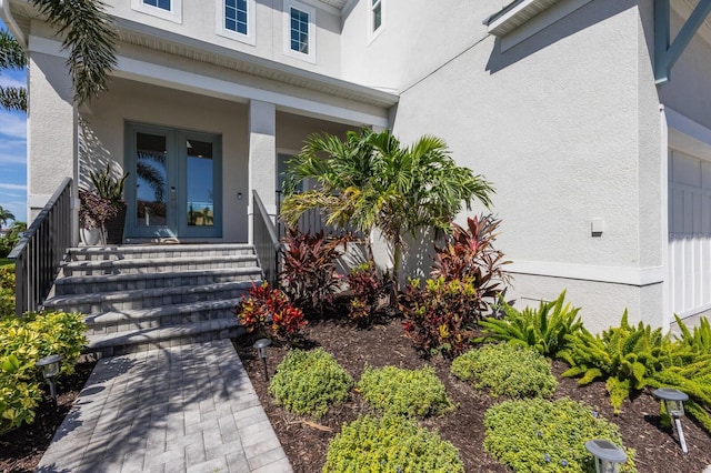 5718 Title Row Dr, Bradenton, FL 34210 - property entrance featuring french doors, stucco siding, and covered porch