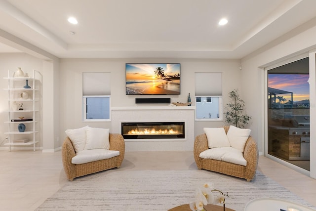 5718 Title Row Dr, Bradenton, FL 34210 - living area with a tray ceiling, a glass covered fireplace, and recessed lighting