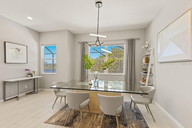 5718 Title Row Dr, Bradenton, FL 34210 - dining room with light wood-style flooring and plenty of natural light