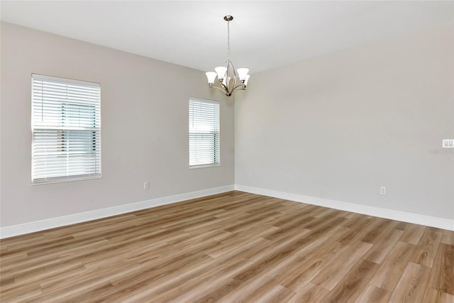 12613 Oak Hill Way, Parrish, FL 34219 - unfurnished room featuring a chandelier, light wood-type flooring, and baseboards