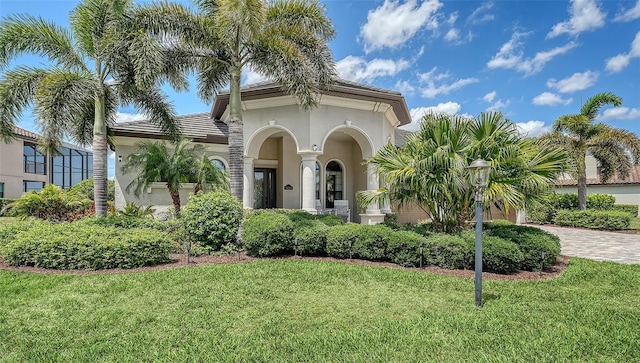 5622 Arnie Loop, Lakewood Ranch, FL 34211 - mediterranean / spanish-style house featuring a front yard, stucco siding, and driveway