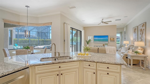 5622 Arnie Loop, Lakewood Ranch, FL 34211 - kitchen featuring cream cabinets, a sink, light stone counters, and crown molding