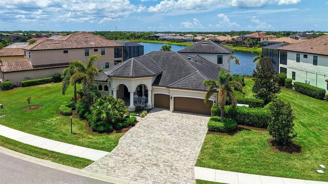 5622 Arnie Loop, Lakewood Ranch, FL 34211 - view of front facade featuring a garage, a residential view, driveway, a water view, and stucco siding