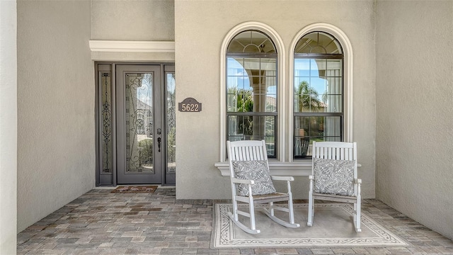5622 Arnie Loop, Lakewood Ranch, FL 34211 - property entrance with stucco siding and covered porch