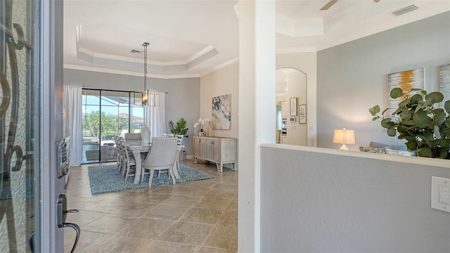 5622 Arnie Loop, Lakewood Ranch, FL 34211 - dining space with a tray ceiling, ornamental molding, arched walkways, and ceiling fan