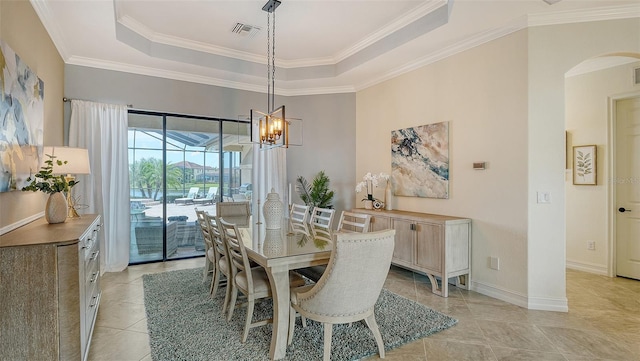 5622 Arnie Loop, Lakewood Ranch, FL 34211 - dining room with arched walkways, a tray ceiling, crown molding, a chandelier, and light tile patterned floors