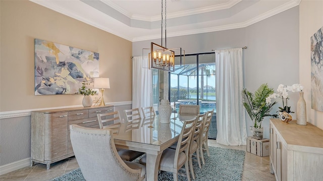 5622 Arnie Loop, Lakewood Ranch, FL 34211 - dining space with a raised ceiling, a chandelier, ornamental molding, and light tile patterned floors